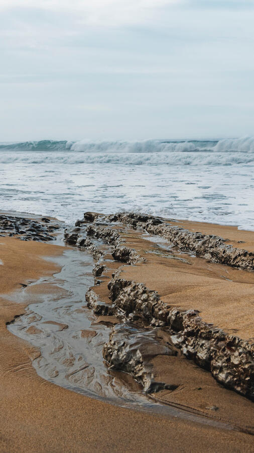 Laguna Beach Stone outcropping and waves 9x16 portrait 2025
